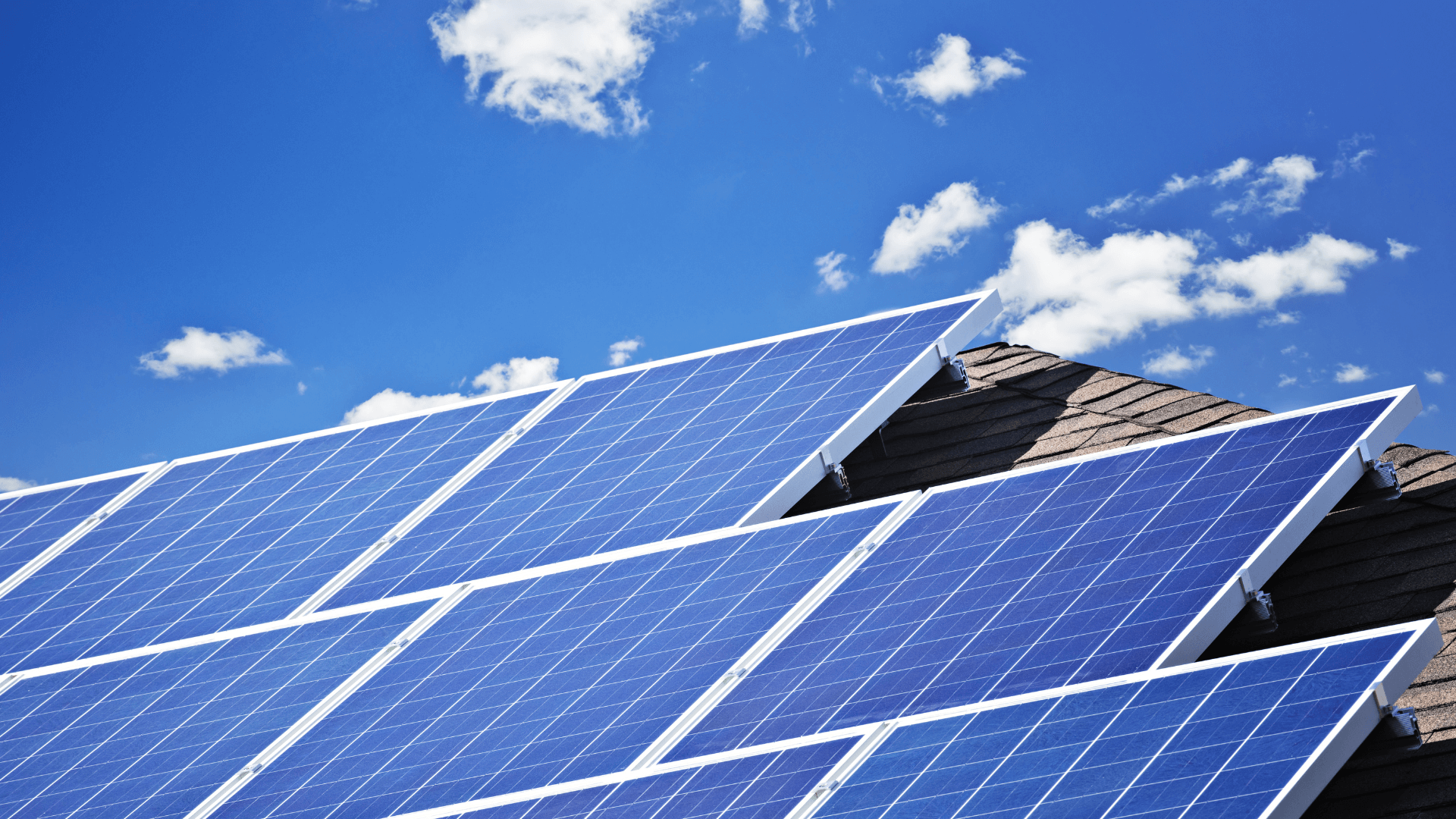 Solar panels on a roof against a blue sky in Val-De-Vie